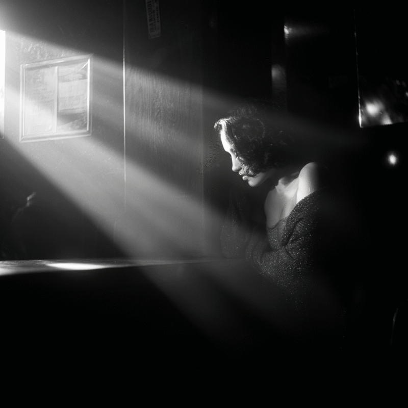 Woman from Moldova, aged 34, sitting alone at a table in a seedy nightclub.